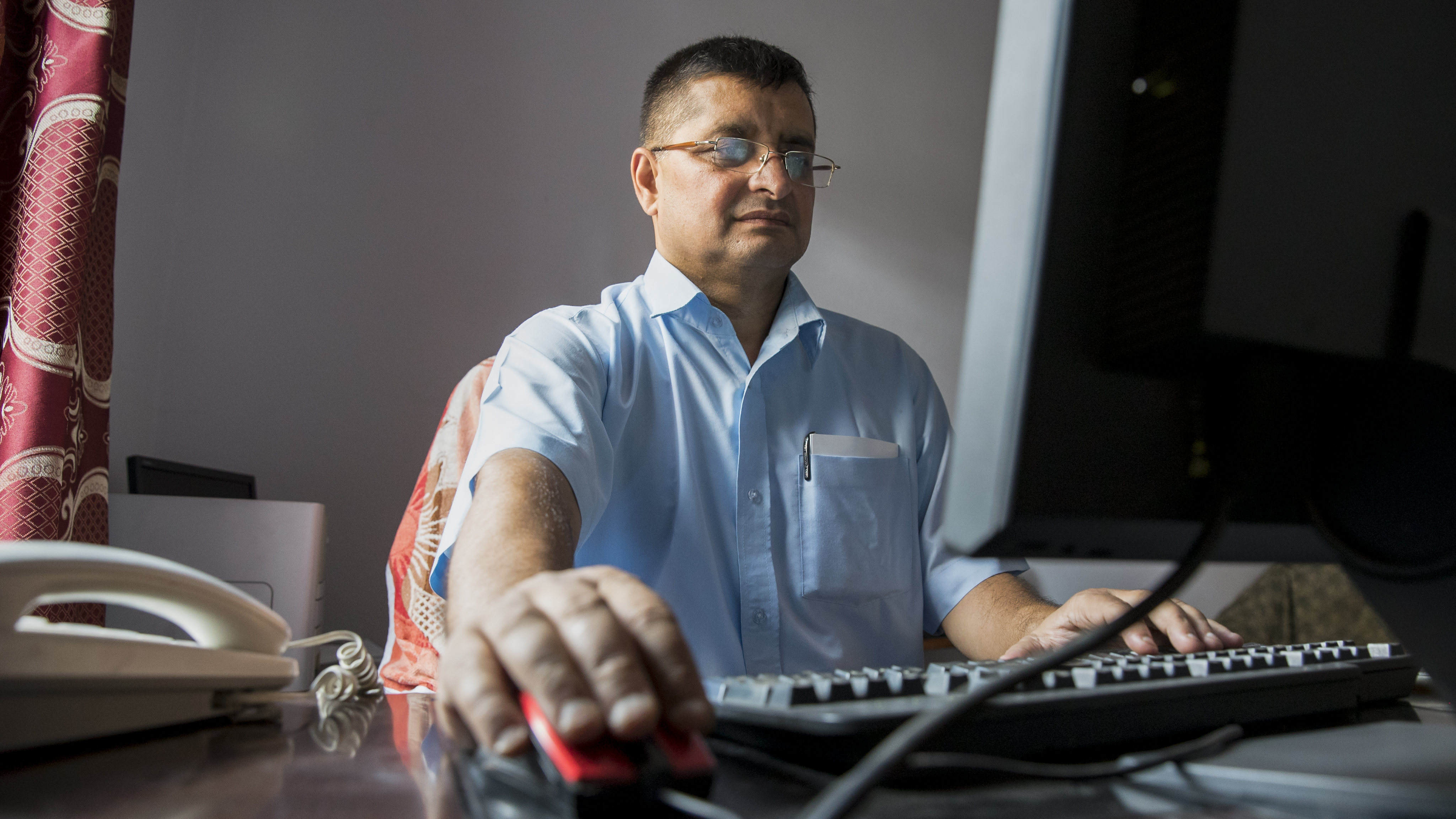 \"man working on computer\"